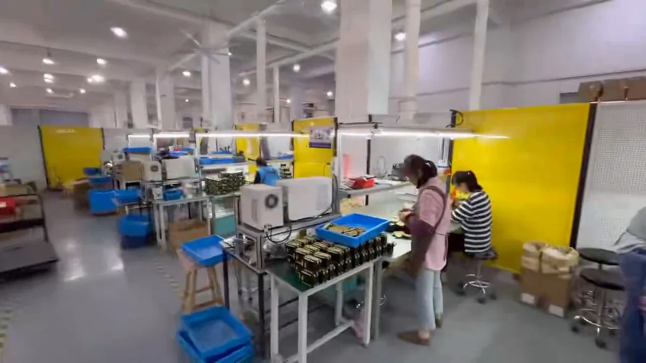 Workers assembling and checking tools at lit benches